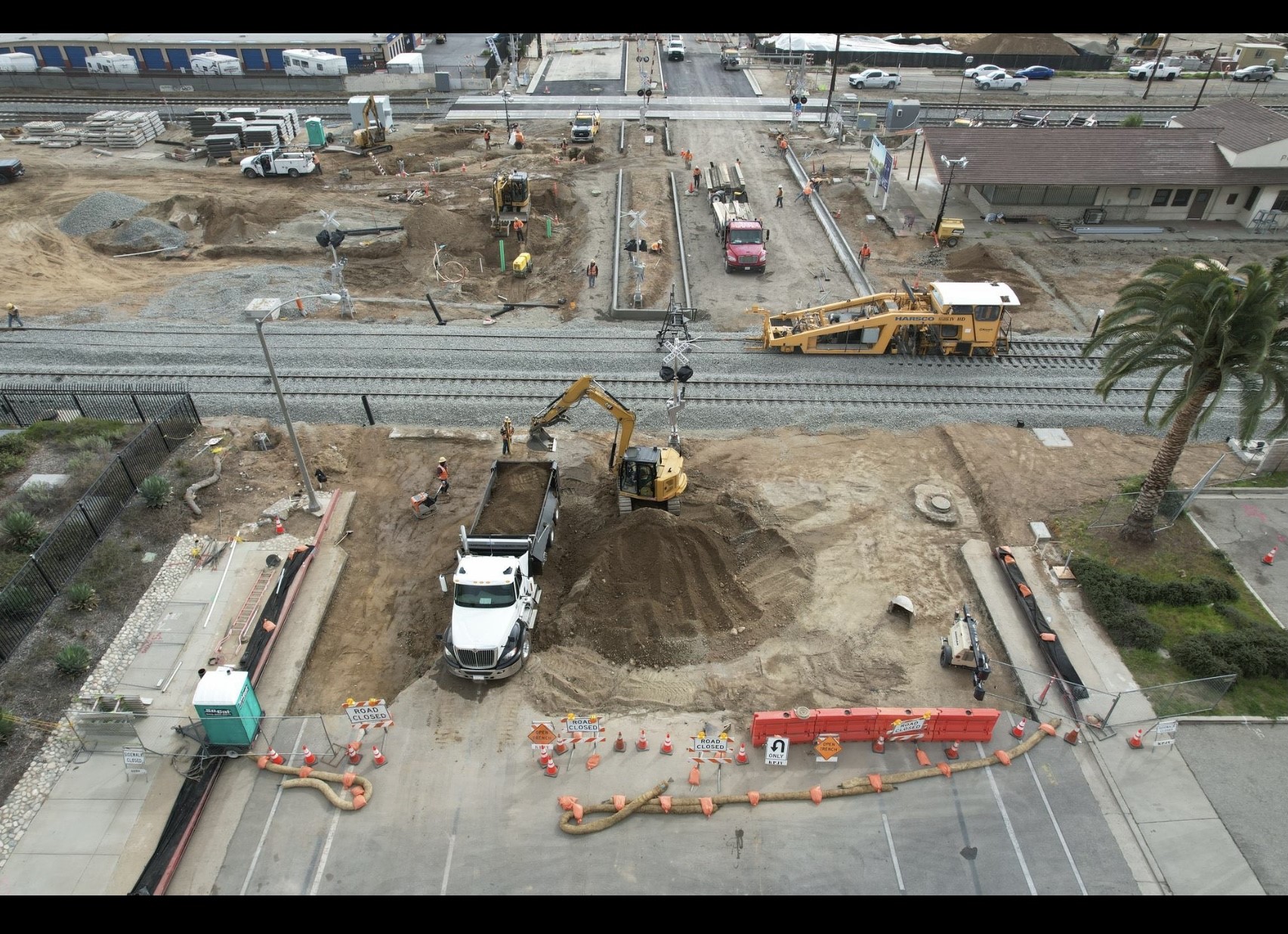Aerial view of a utility construction site with crews and equipment